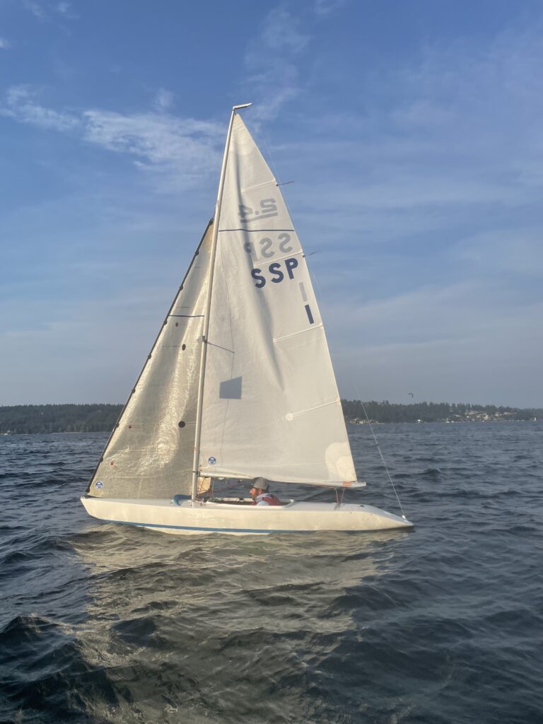 The 2.4mR sailboat is a popular choice for adaptive sailing due to its design that allows for easy access and control from a seated position. It's a single-handed keelboat where the sailor sits facing forward, and all controls are within reach, making it accessible for sailors of various abilities.